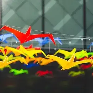 Colourful artificial birds hanging from wires
