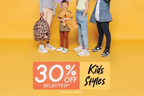 Group of kids standing against a yellow background