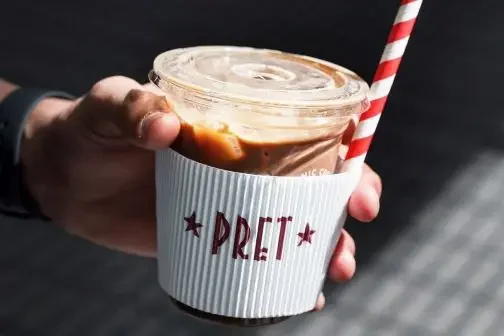Person holding a iced coffee from Pre a Manger